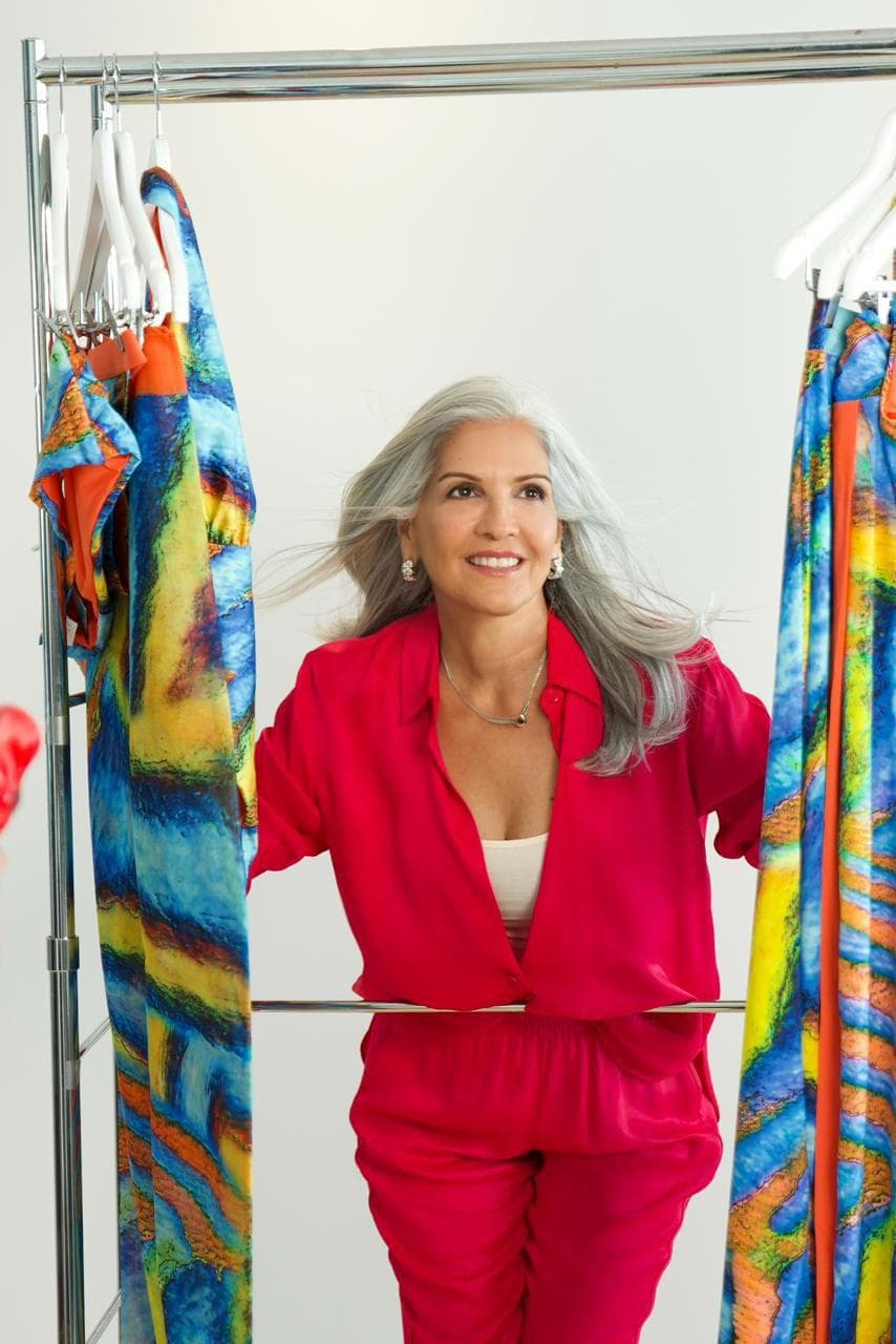 Ofelia Méndez among racks of her swimwear designs